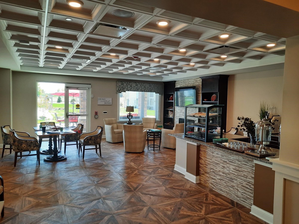 A modern cafe interior with a seating area and counter.