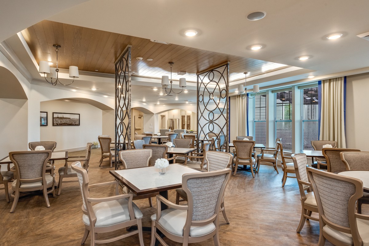 A modern dining area with elegant furniture and warm lighting.