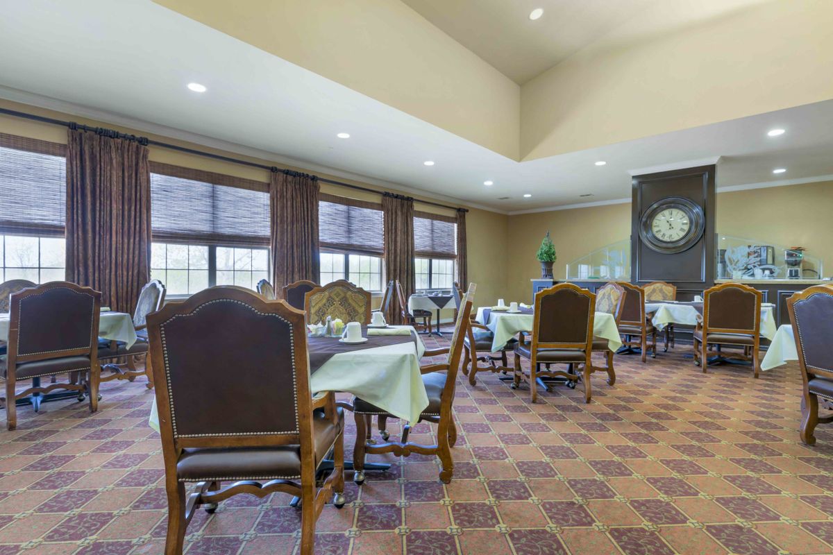 An elegant dining room with neatly arranged tables and chairs.