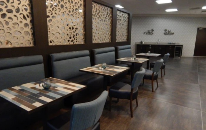A modern restaurant dining area with neatly arranged tables and chairs.