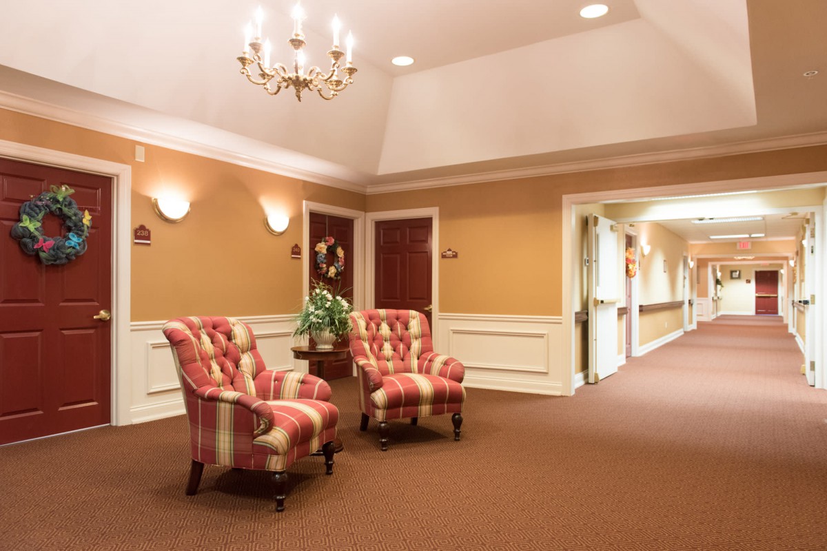 A cozy lobby area with armchairs and warm lighting.