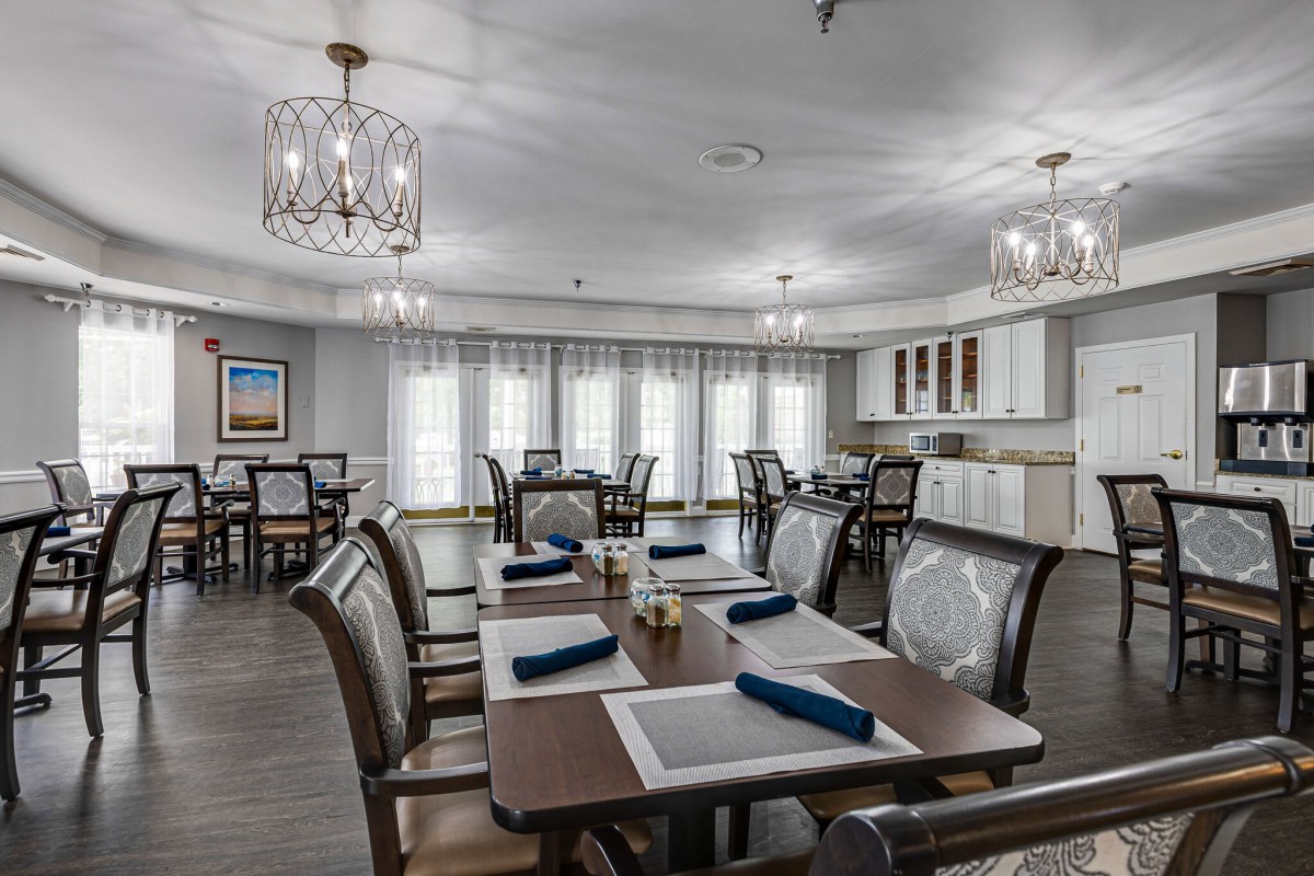 A modern and elegant dining room with neatly arranged tables and place settings.