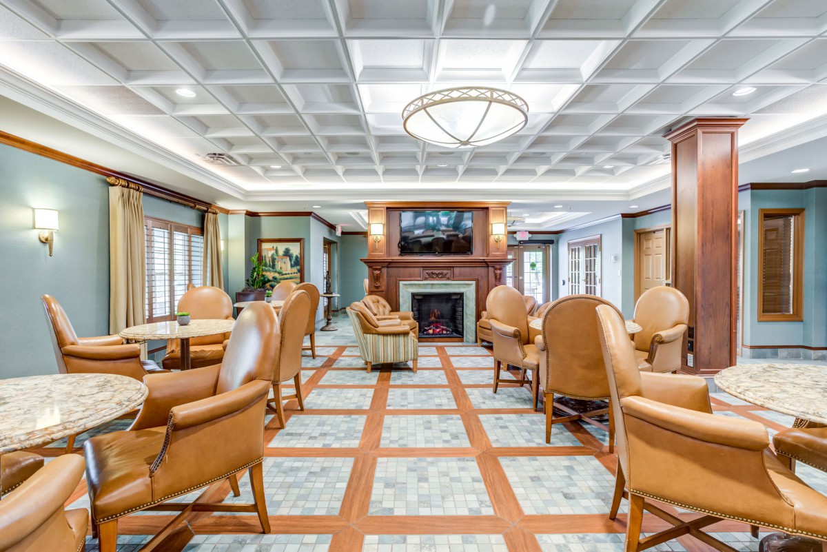 A luxurious lounge area with comfortable seating, featuring a fireplace and elegant lighting.