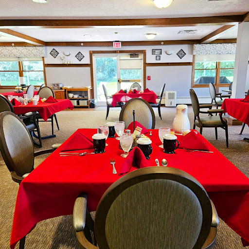 A beautifully arranged dining area featuring red tablecloths and a cozy atmosphere.