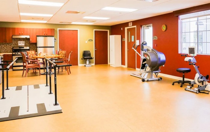 A rehabilitation center's therapy room equipped with exercise machines.