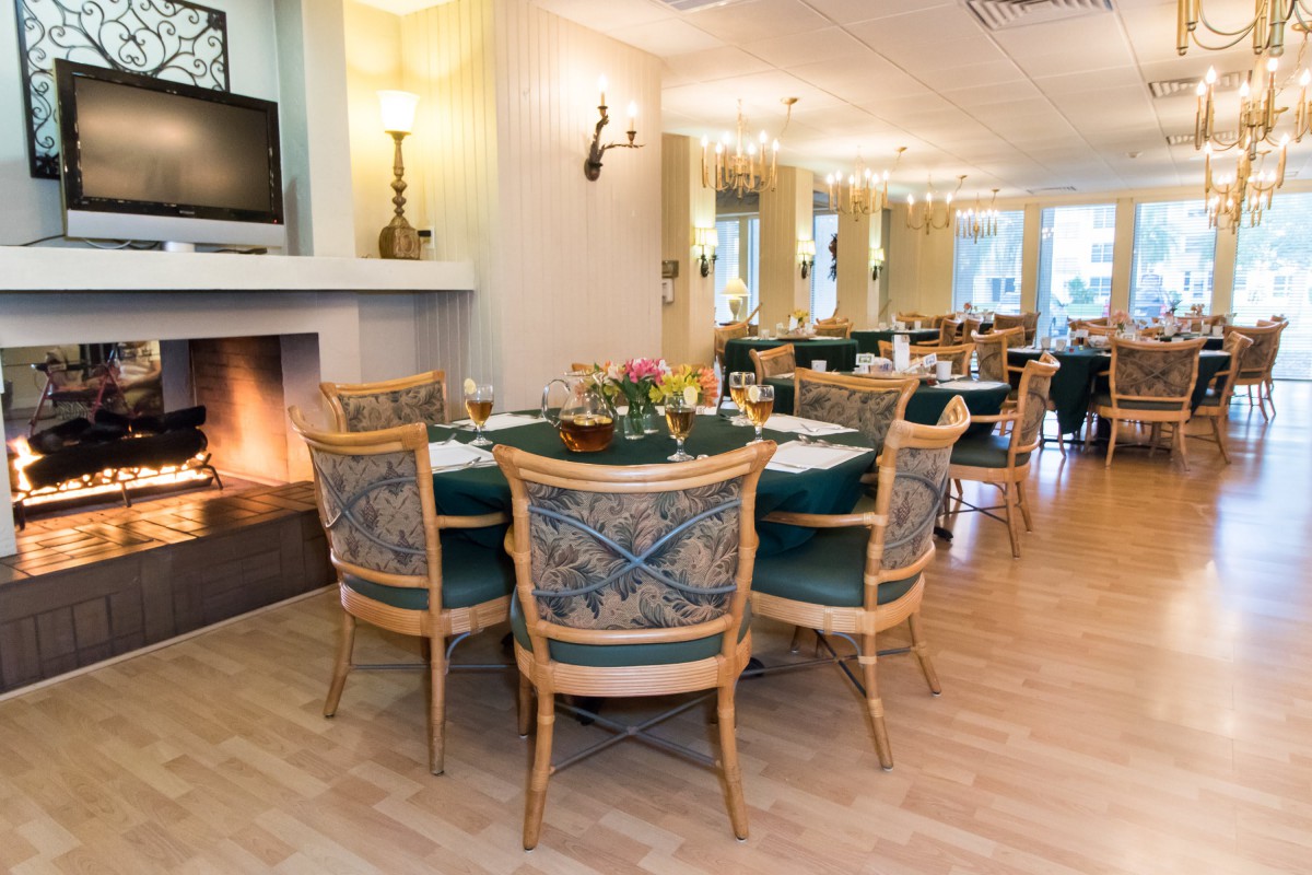 Elegant restaurant dining area with cozy fireplace and stylish furnishings.