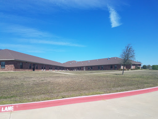 A view of a school building set against a clear blue sky.