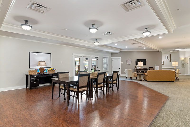 A spacious and modern dining area with hardwood floors and elegant lighting.