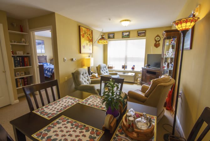 A cozy living room with a dining area, featuring comfortable furniture and warm decor.