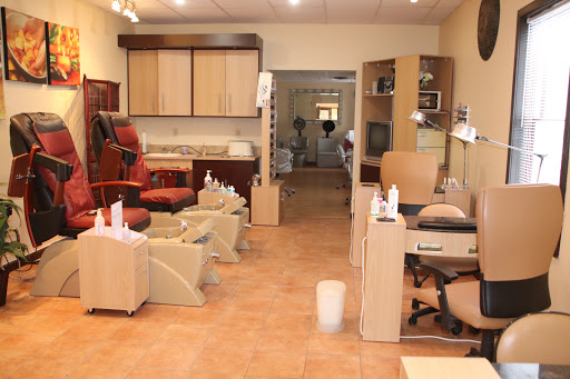 A tranquil nail salon interior featuring manicure and pedicure stations.