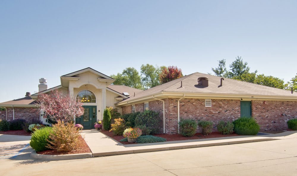 A charming suburban house with brick exterior and well-maintained landscaping.