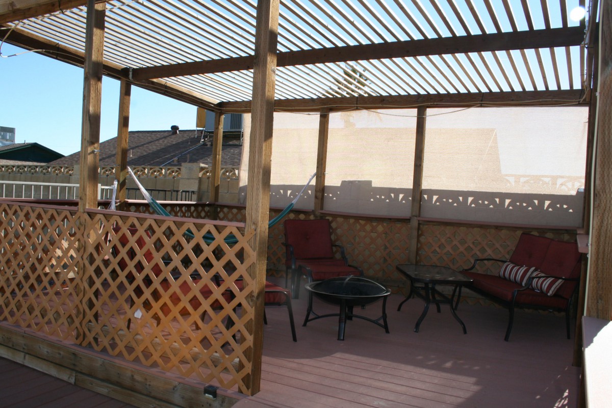 Outdoor patio with a pergola and seating area.
