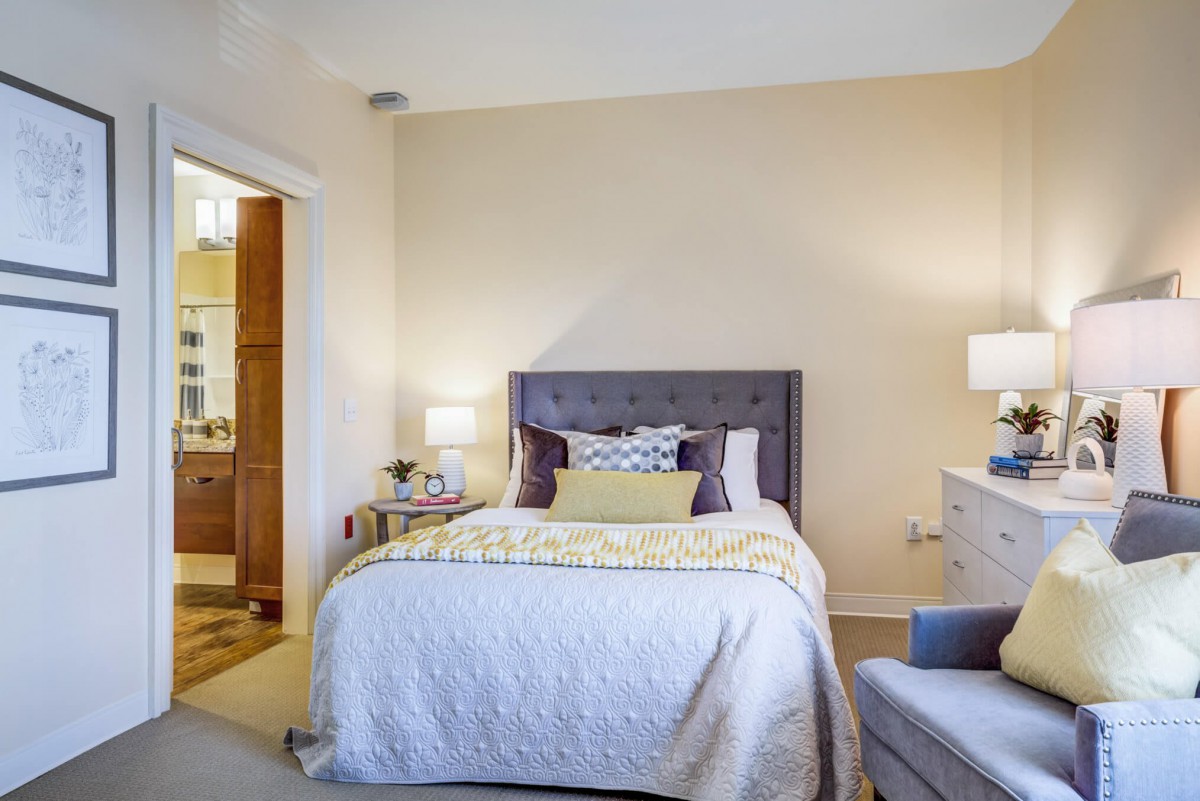 A cozy and well-decorated bedroom with a large bed, pillows, and bedside lamps.