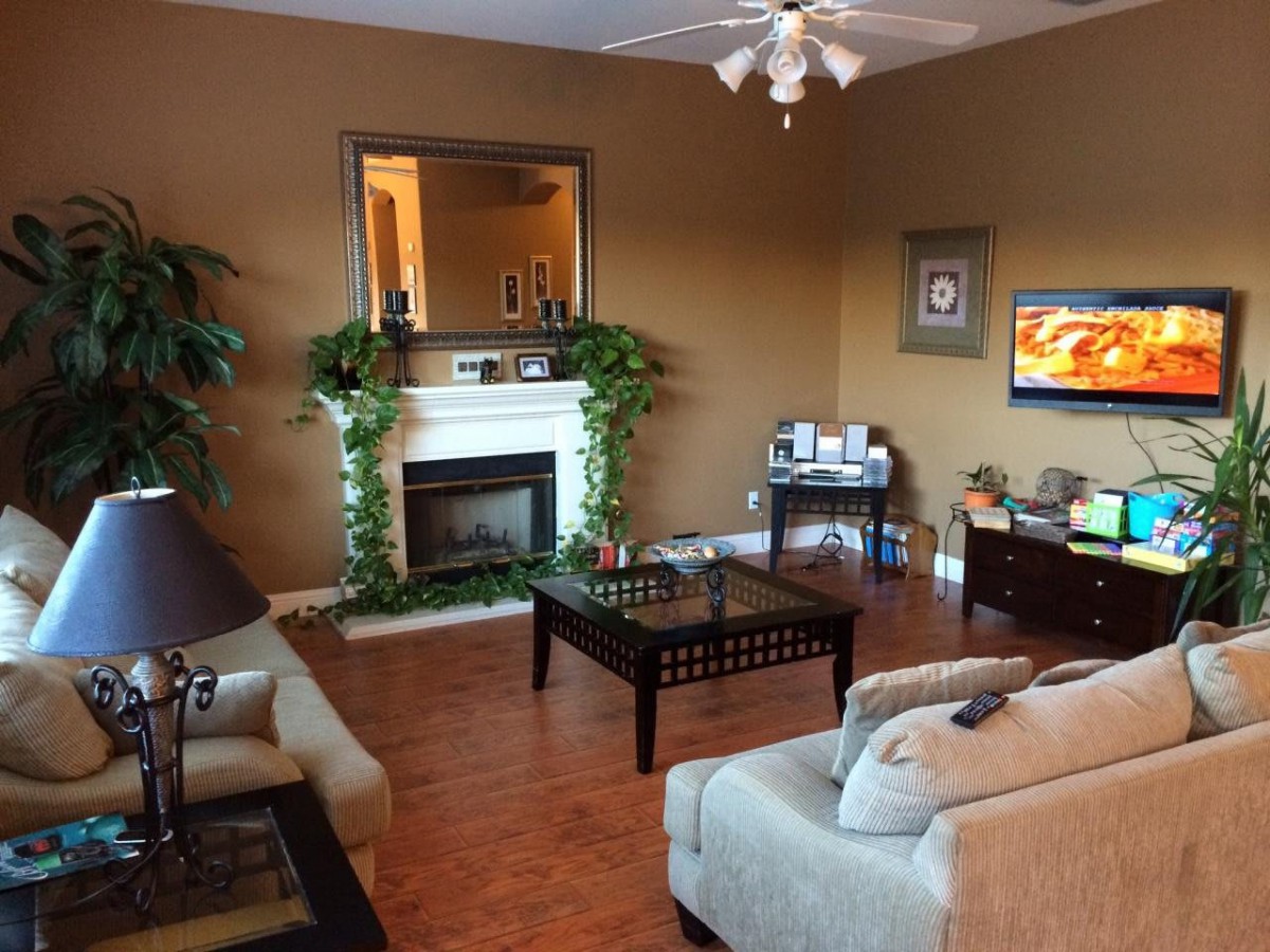 A cozy living room featuring a fireplace, comfortable seating, and warm decor.