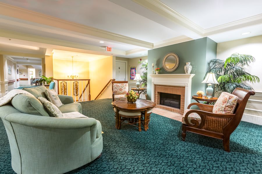 A cozy living room featuring a fireplace, comfortable seating, and tasteful decor.