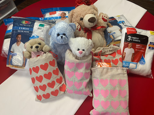 A collection of adorable stuffed animals wrapped in cozy socks, perfect for gifting or cuddling.