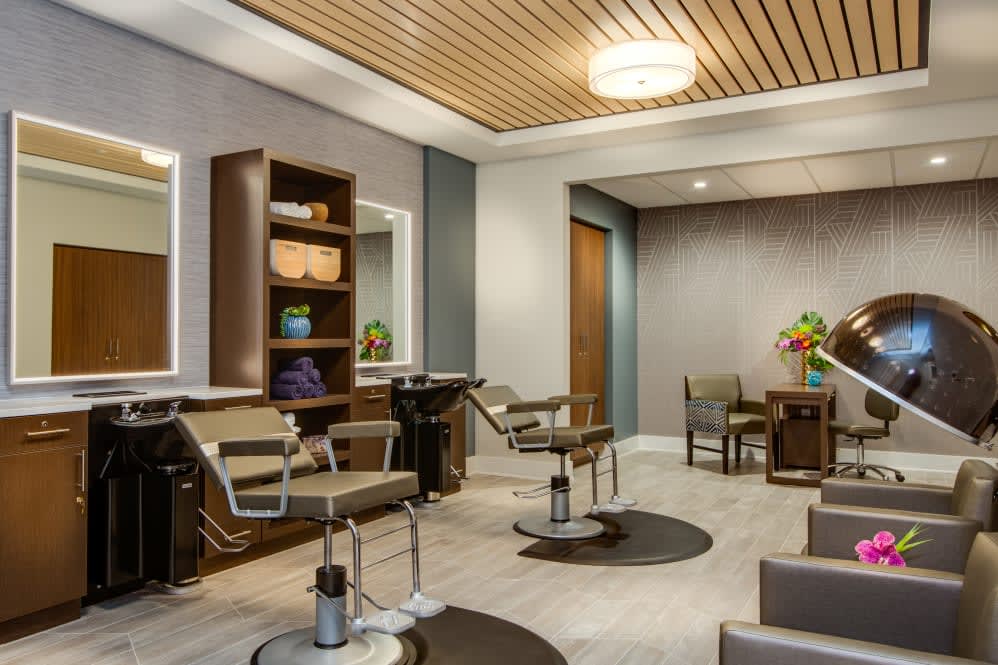 A modern hair salon with stylish chairs, mirrors, and a welcoming waiting area.