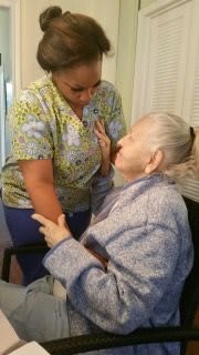 A caregiver assists an elderly person with care and support.
