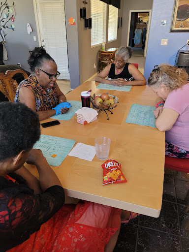 A group of individuals enjoying a bingo game while sharing snacks.