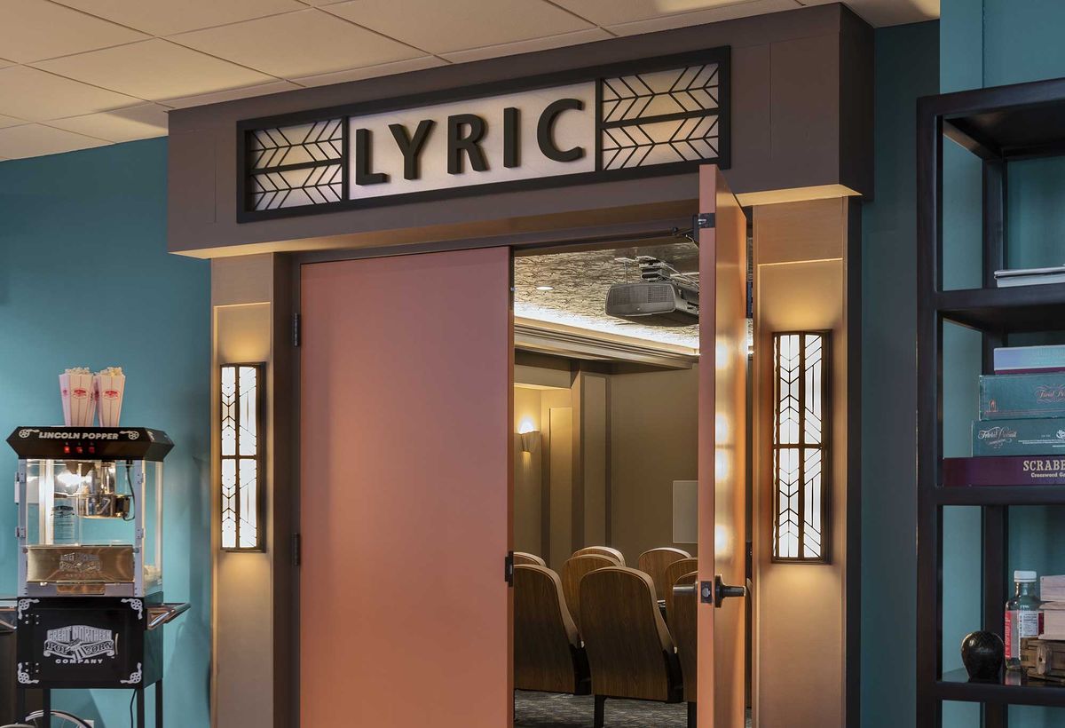 Entrance to a vintage-style theater named 'Lyric' with art deco design elements.