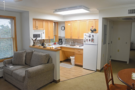 A cozy apartment featuring a combined kitchen and living space with modern appliances and comfortable seating.