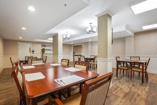 A spacious and modern dining area featuring wooden furniture and ample lighting.