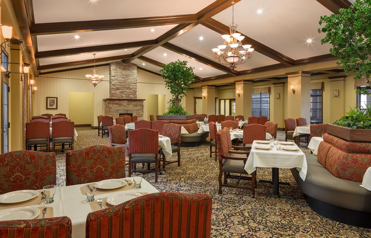 An elegant restaurant dining area with neatly set tables and comfortable seating.