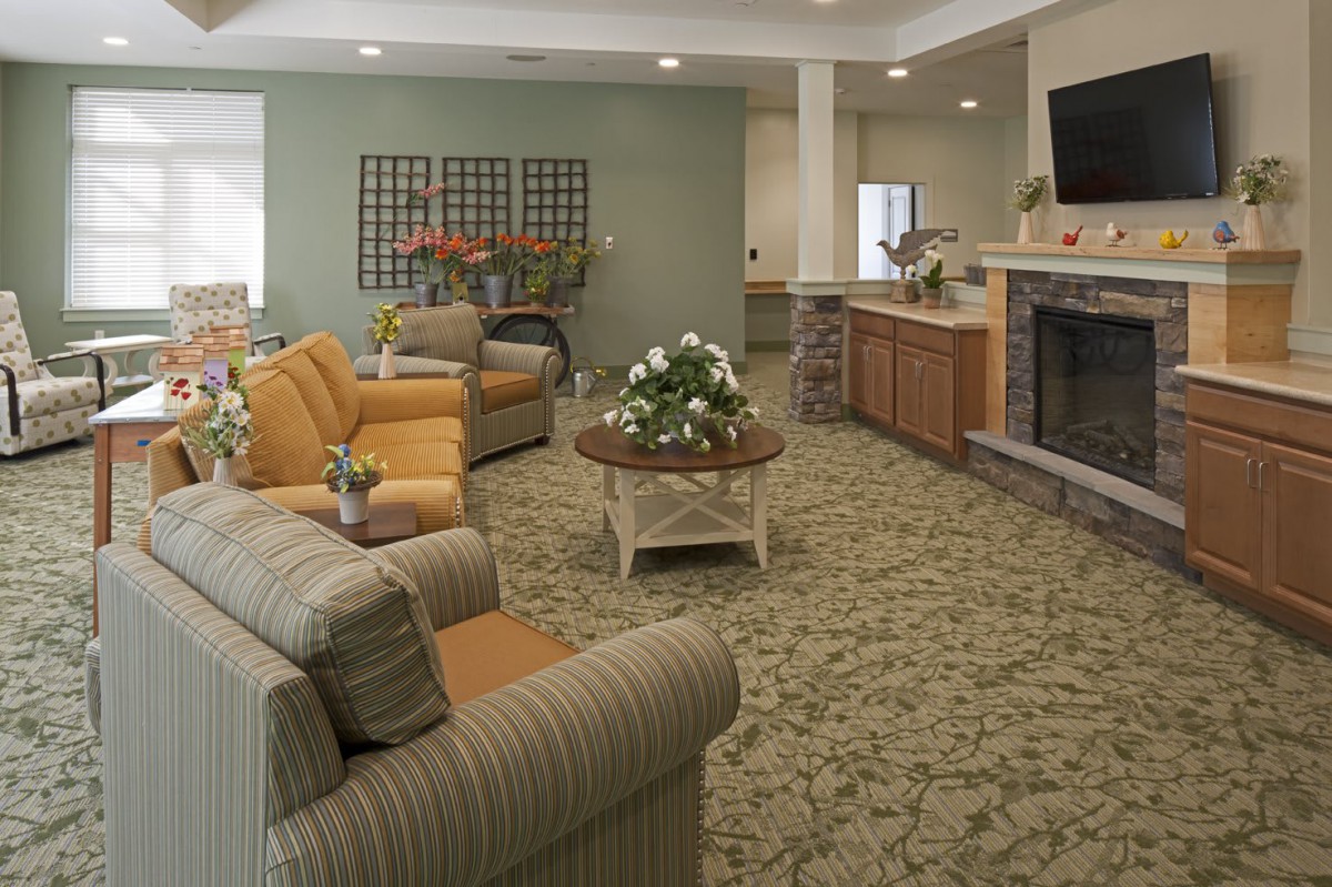 A cozy living room with comfortable seating, a coffee table, and a fireplace.