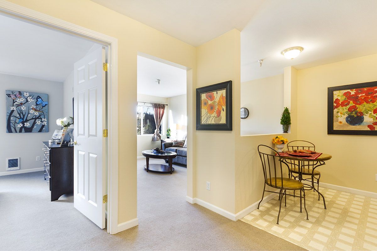 A cozy interior featuring a living room and dining area with modern furniture and artwork on the wall.