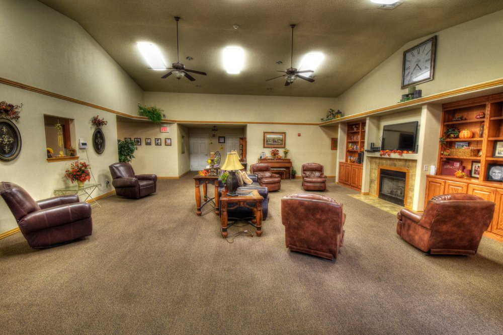 A spacious living room with comfortable seating and warm lighting.