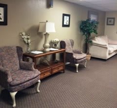 A cozy waiting room with plush chairs and decorative elements.
