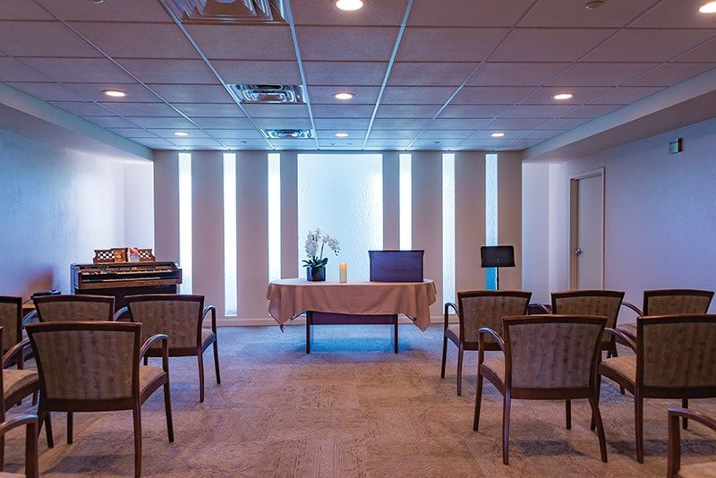 A well-lit conference room with chairs arranged facing a table.