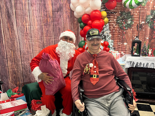 A festive moment captured with Santa Claus and an elderly gentleman enjoying the holiday spirit together.