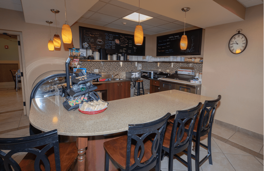 A cozy cafe interior with a bar counter and menu board.