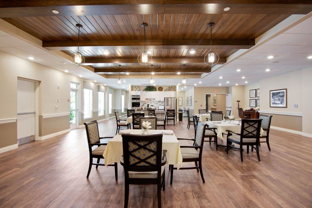 A spacious dining area with elegantly set tables and a warm, inviting atmosphere.
