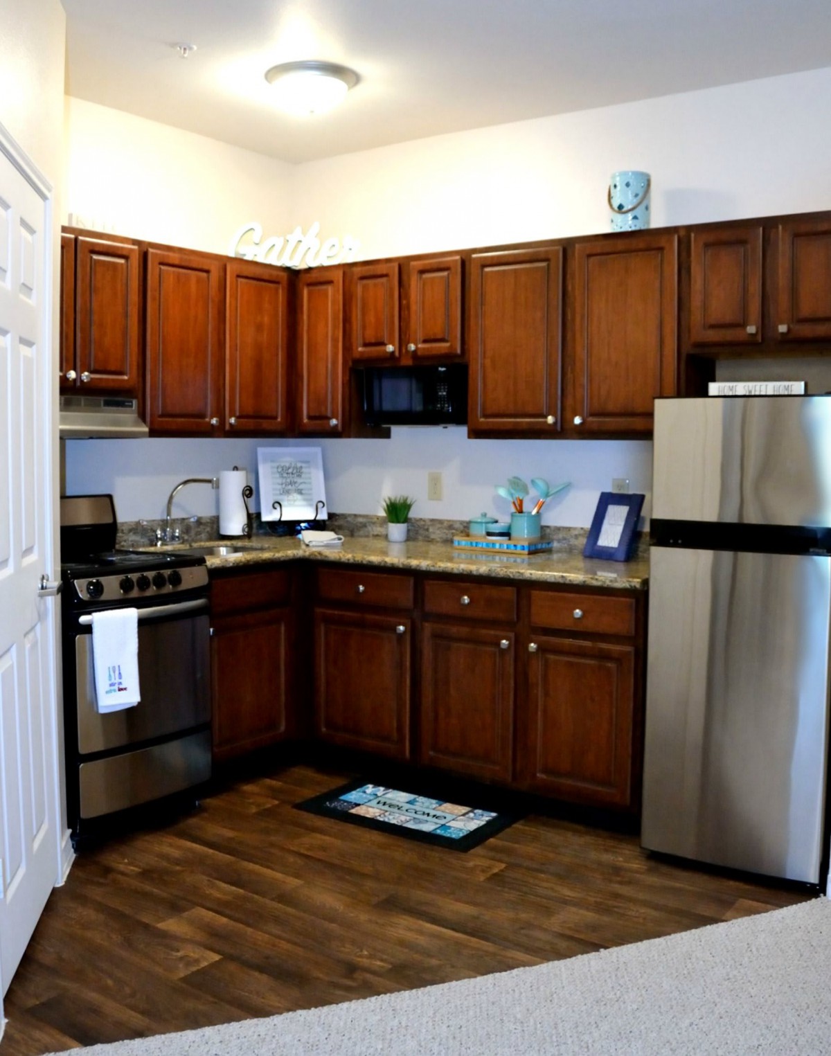 A modern kitchen with wooden cabinets and stainless steel appliances.