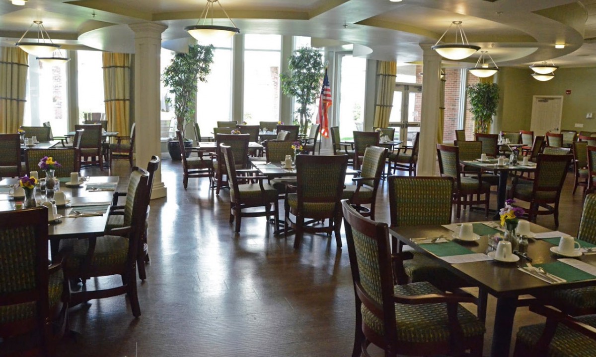 An empty dining room with tables and chairs neatly arranged.