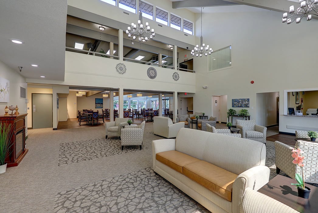A spacious and modern lobby area featuring comfortable seating and elegant lighting fixtures.