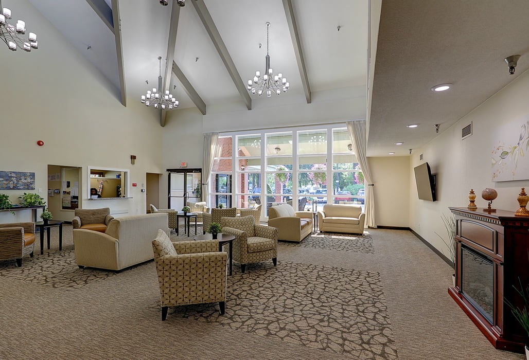 A spacious lobby with comfortable seating and large windows allowing natural light to fill the room.