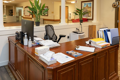 A well-organized office desk with office supplies, plants, and technology.