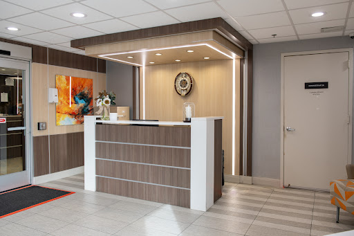 A modern reception area featuring stylish furniture and contemporary lighting.