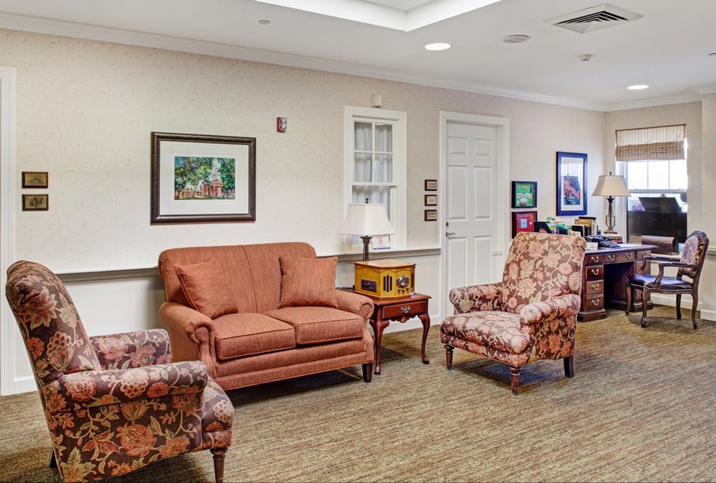 A cozy waiting room with comfortable seating and decorative artwork.