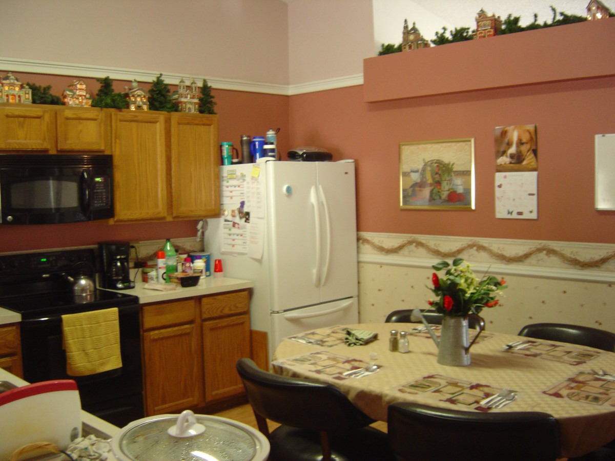 Cozy kitchen and dining area with decorative elements and a table set for meals.
