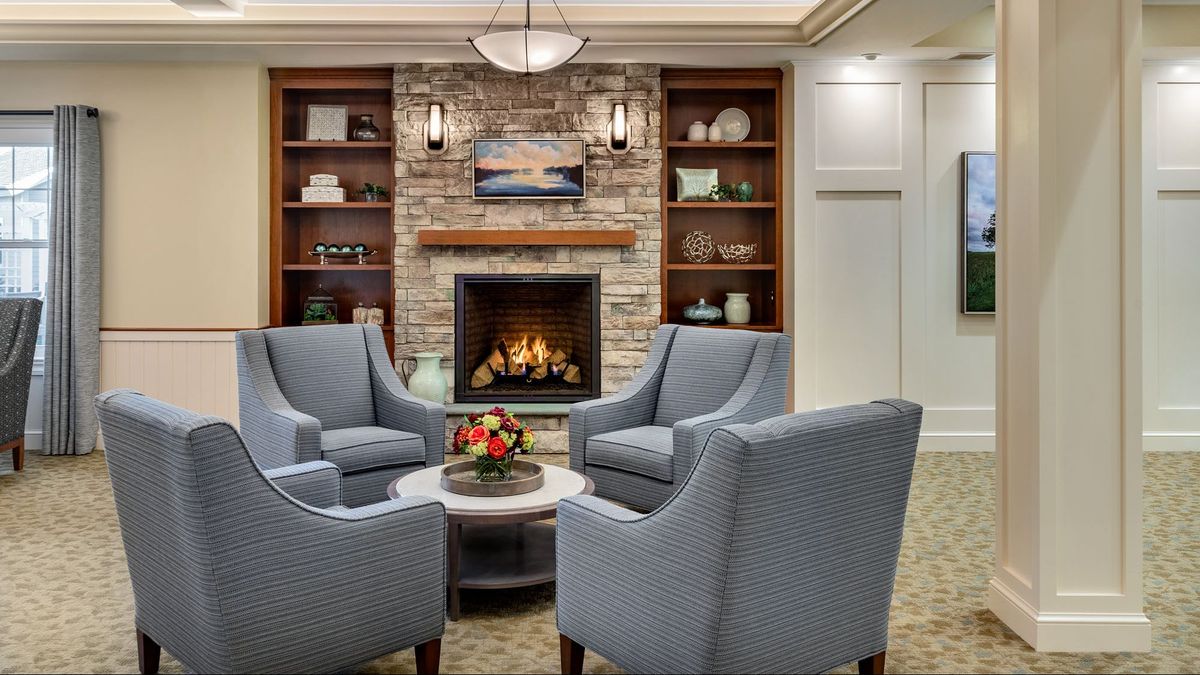 A cozy living room with a brick fireplace and comfortable seating.