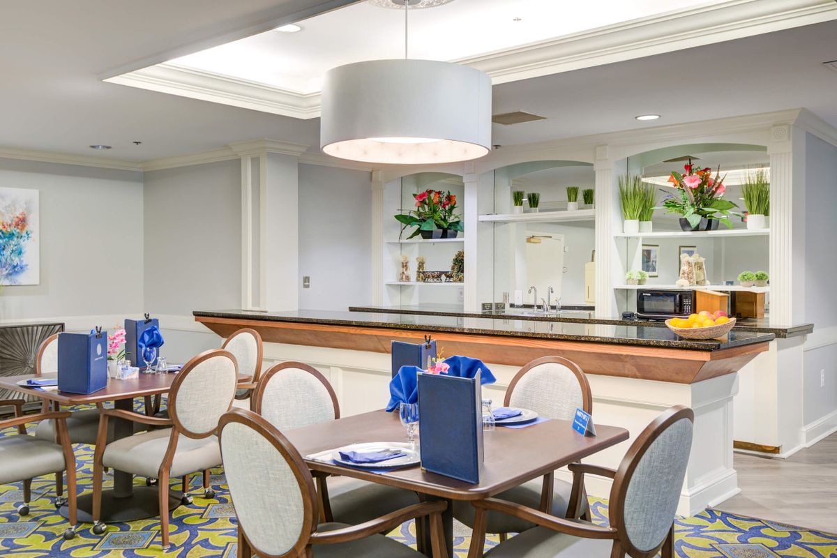 A modern dining room with elegant furniture and contemporary lighting.