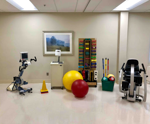 A well-equipped rehabilitation room featuring various fitness and therapy tools.