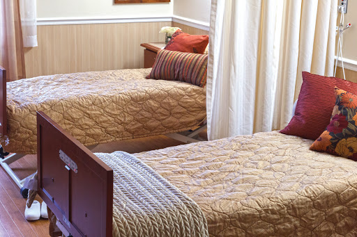 A cozy bedroom featuring two twin beds with decorative bedding and pillows.