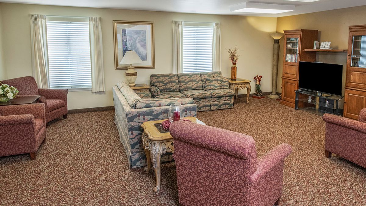 A cozy living room with patterned furniture and decorative elements.