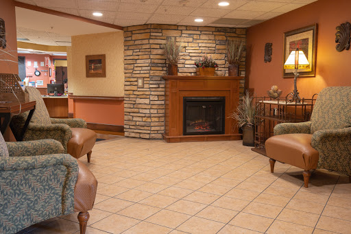 A cozy and welcoming lobby featuring a stone fireplace and comfortable seating.