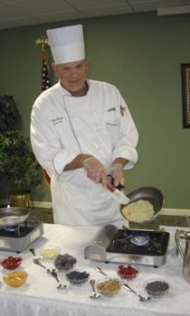 A chef skillfully preparing a dish in the kitchen.
